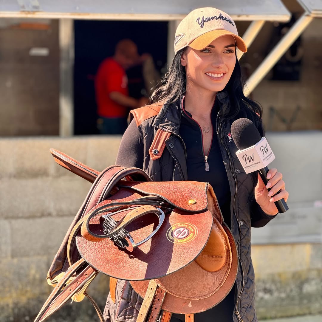 Geena Lucile holding a Weber Tack saddle